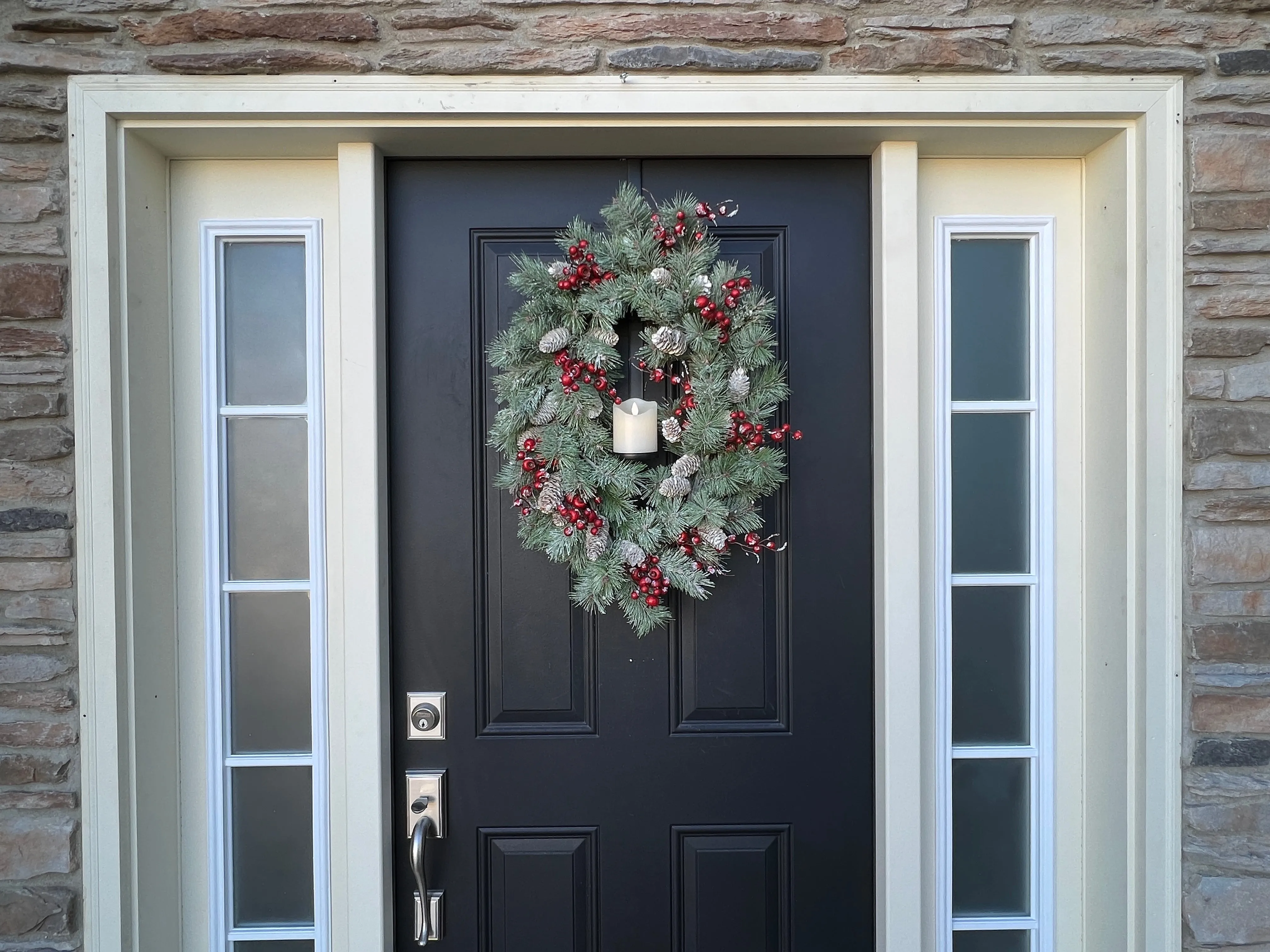 Oval Flocked Winter Pine Wreath with Flickering Candle