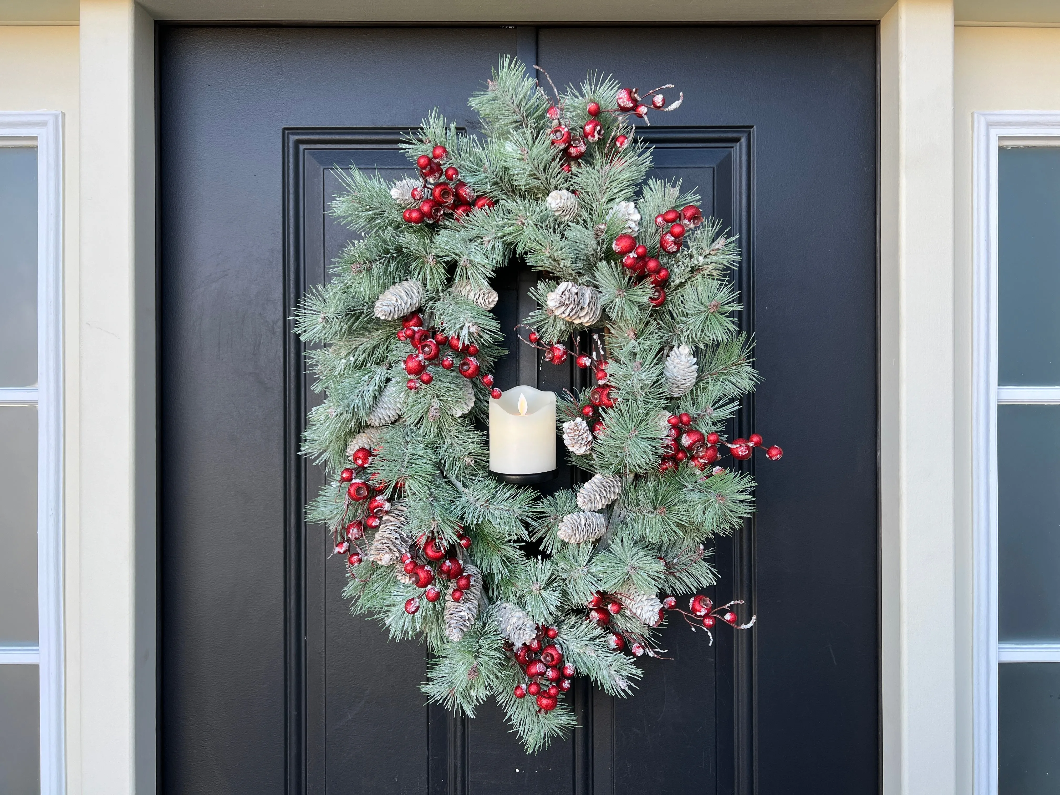 Oval Flocked Winter Pine Wreath with Flickering Candle