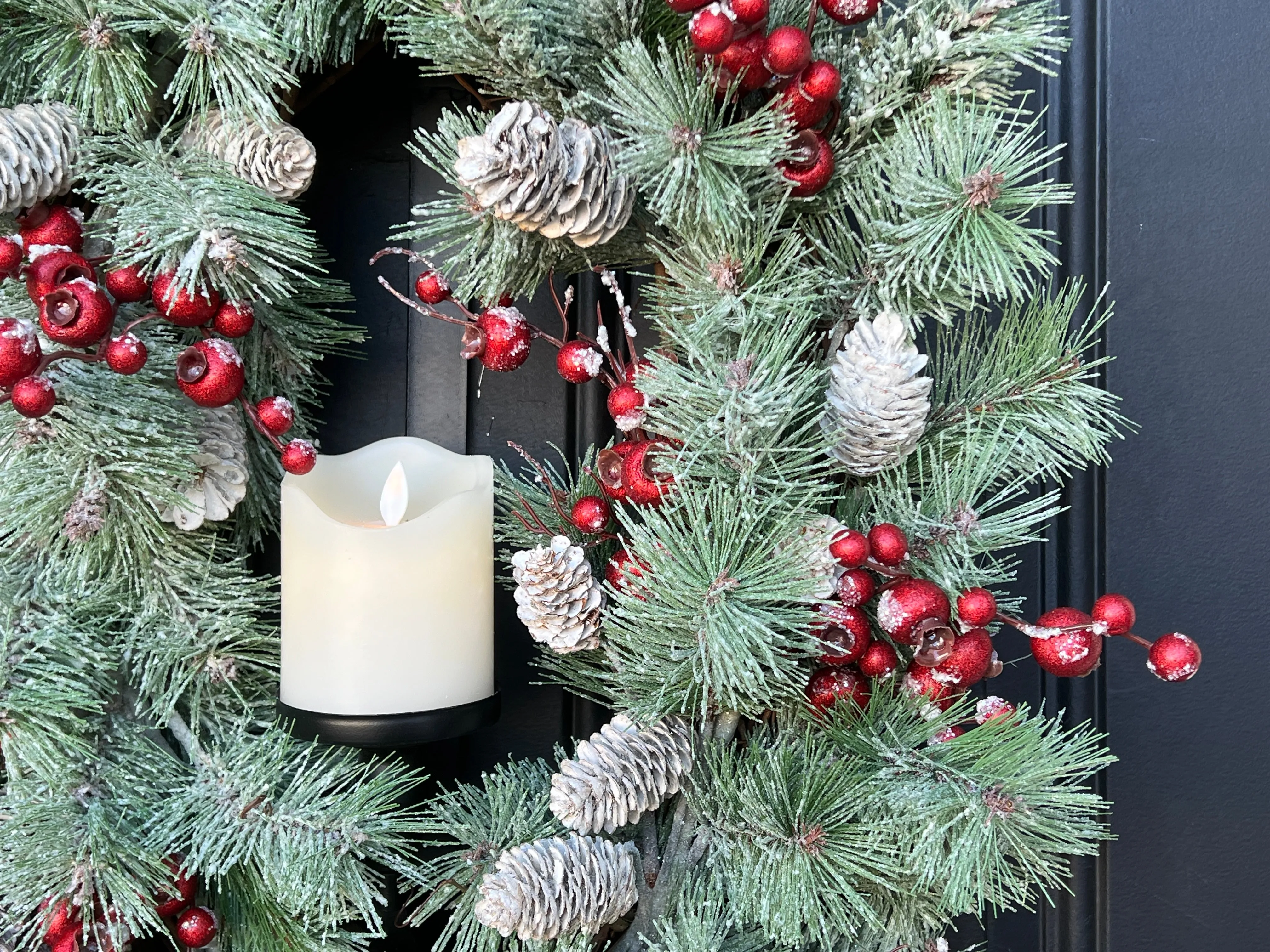Oval Flocked Winter Pine Wreath with Flickering Candle