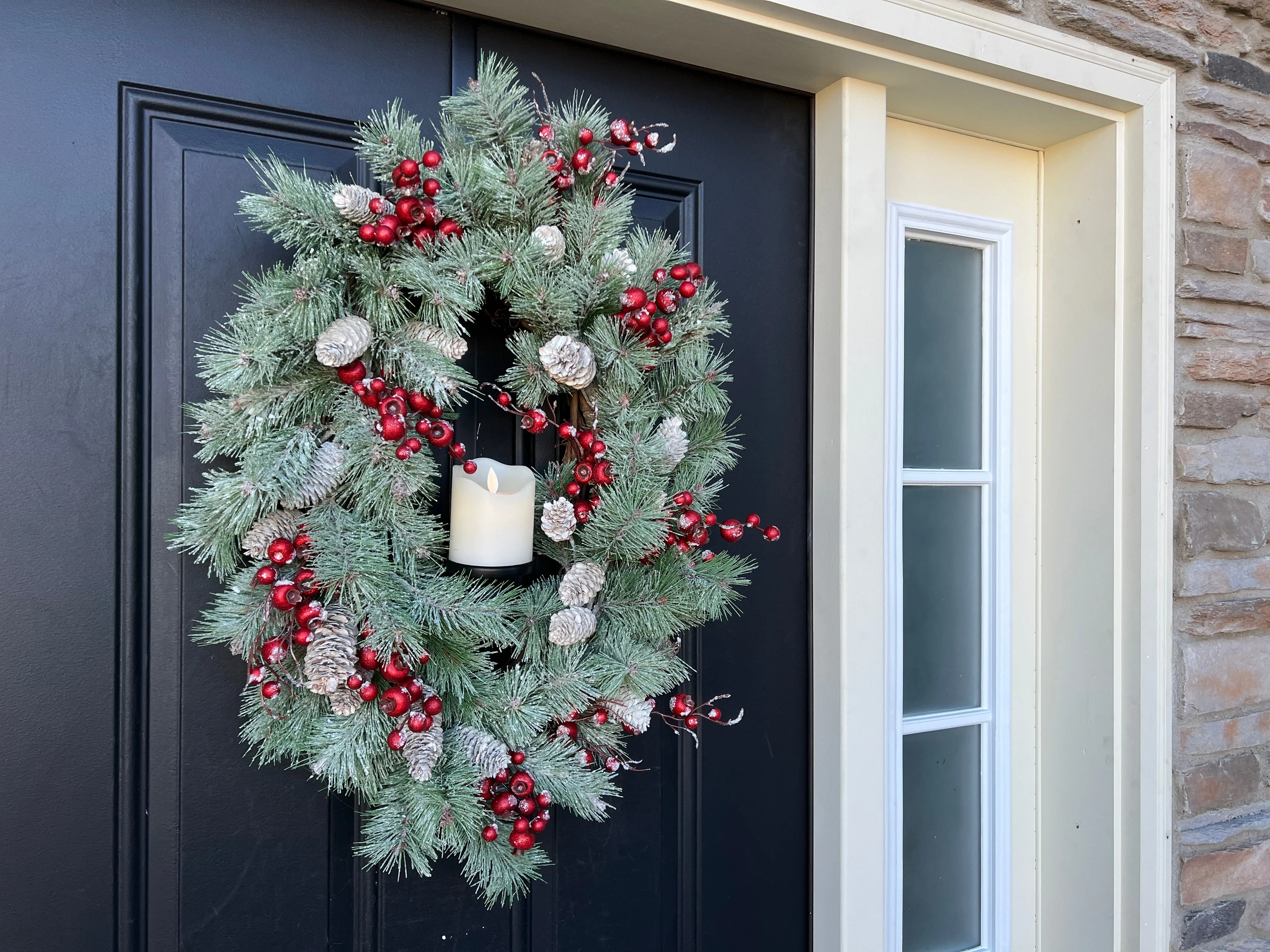 Oval Flocked Winter Pine Wreath with Flickering Candle